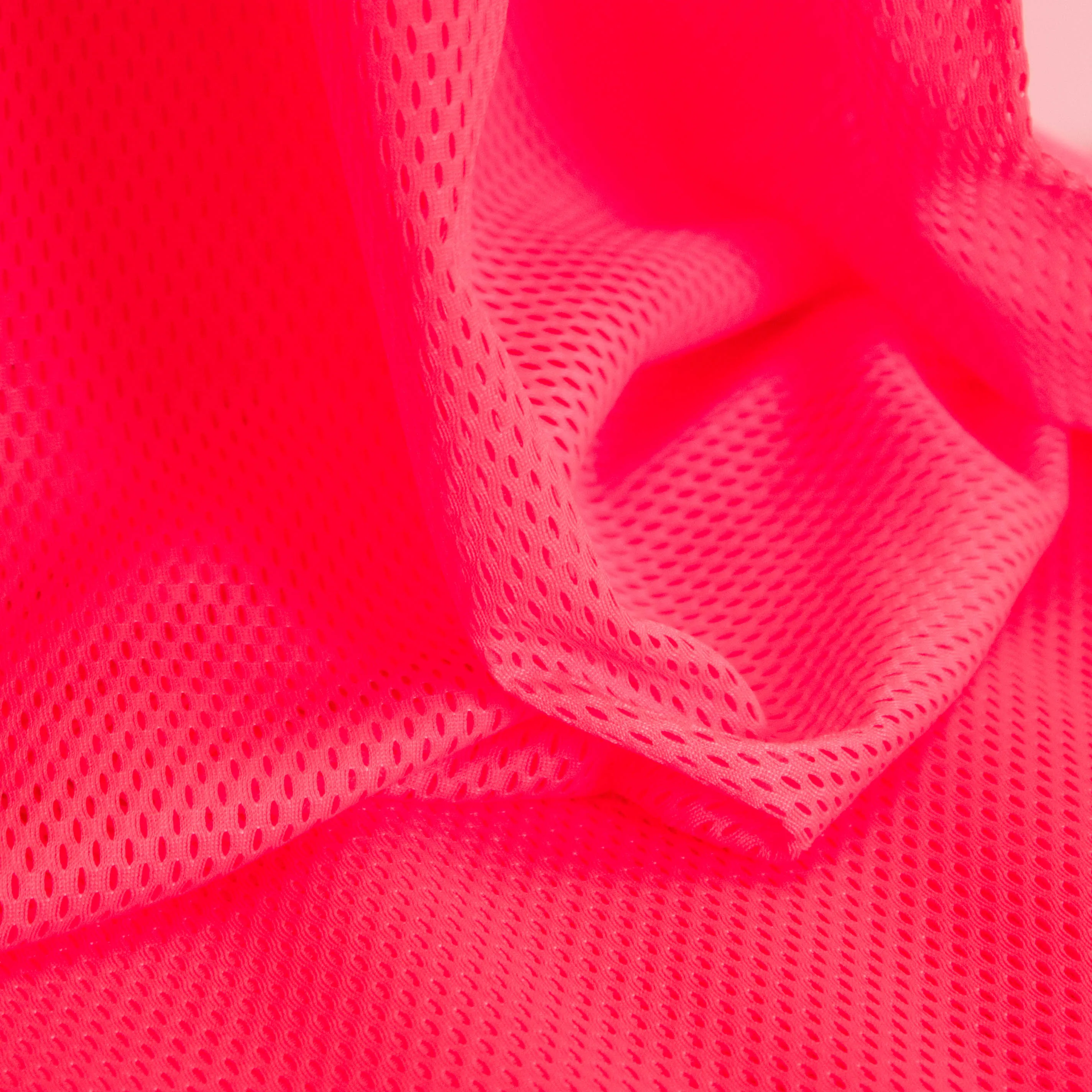 polyester stretch met gaatjes fluo roos